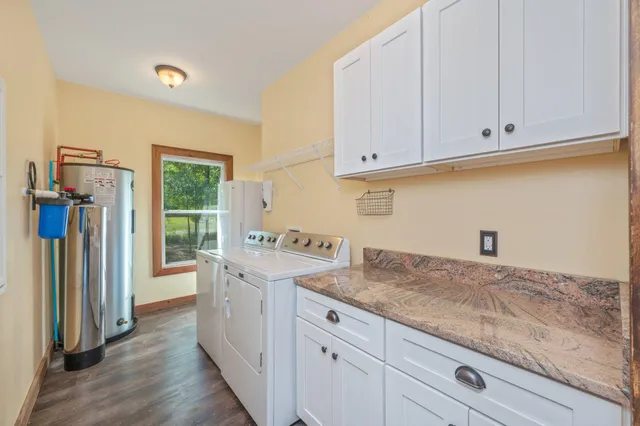 a kitchen with granite countertop a sink and a stove