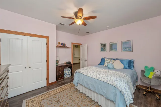 a bedroom with a bed and a chandelier