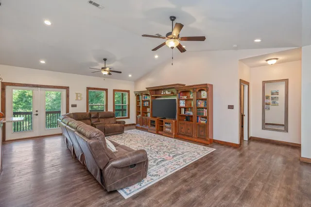 a living room with furniture and wooden floor