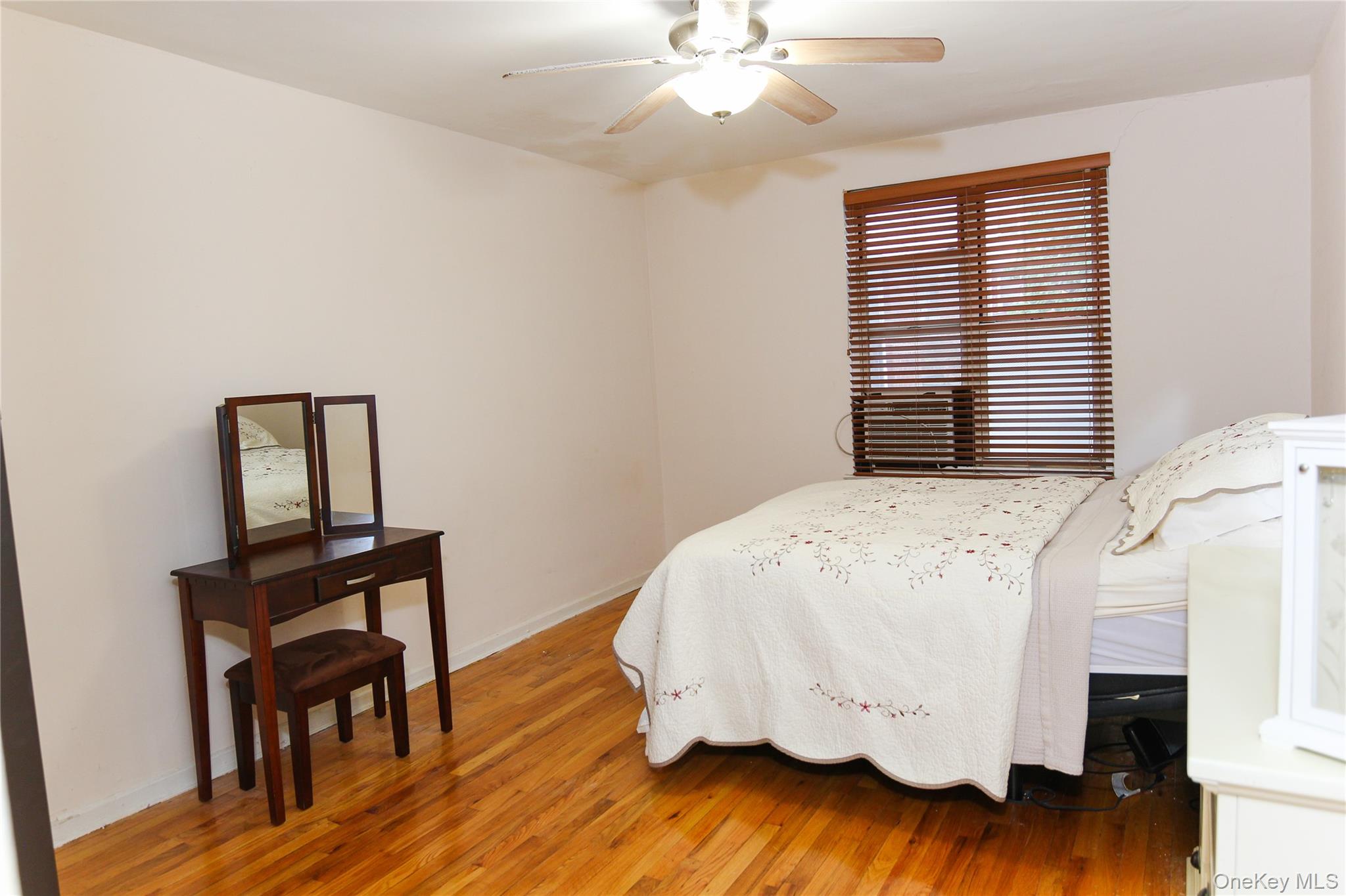 102 Spruce Street, Unit 2A Yonkers, NY 10701 - Photo 11 of 12 a bedroom with a bed and wooden floor