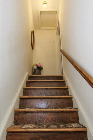 a view of staircase with white walls and railing
