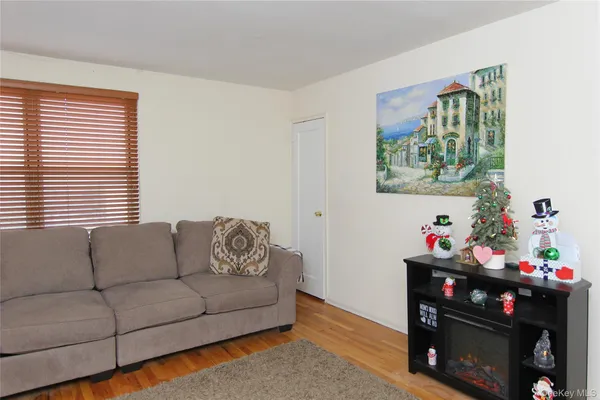 a living room with furniture a fireplace and a window