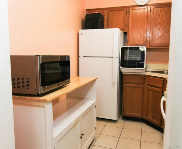 a kitchen with a refrigerator and a microwave