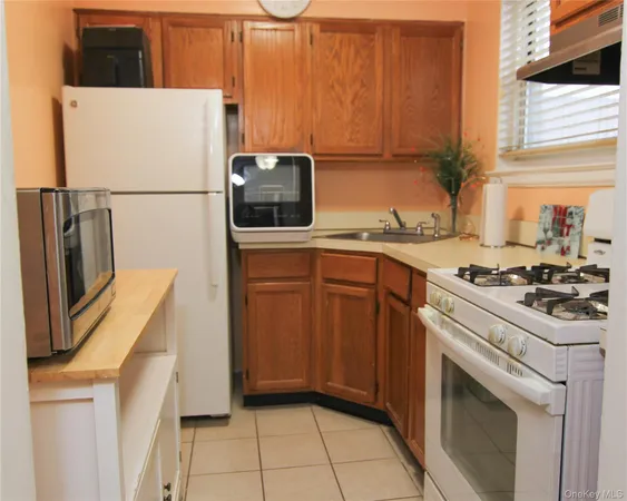 a kitchen with a sink a refrigerator and a stove