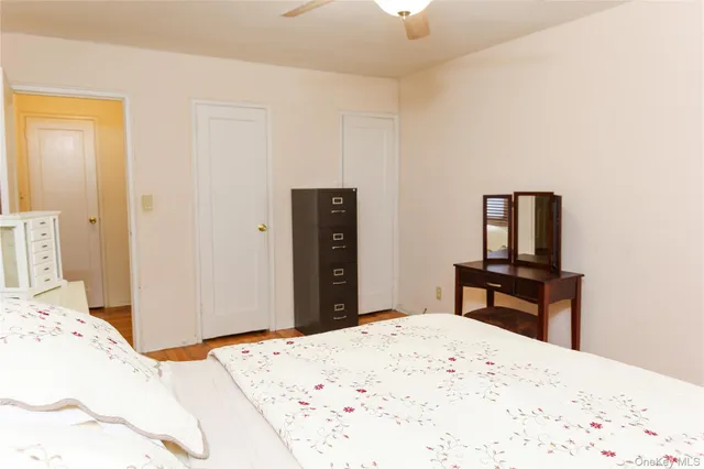 a bedroom with a bed and a dresser in it