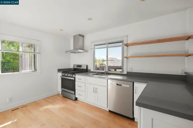 a kitchen with stainless steel appliances a stove and a sink
