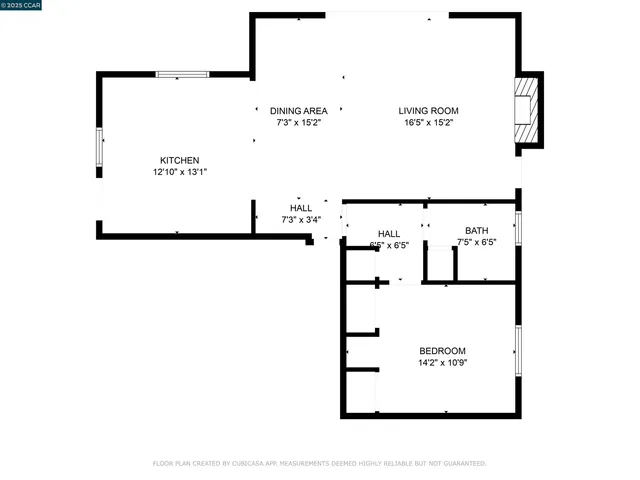 wooden floor fireplace and windows in an empty room