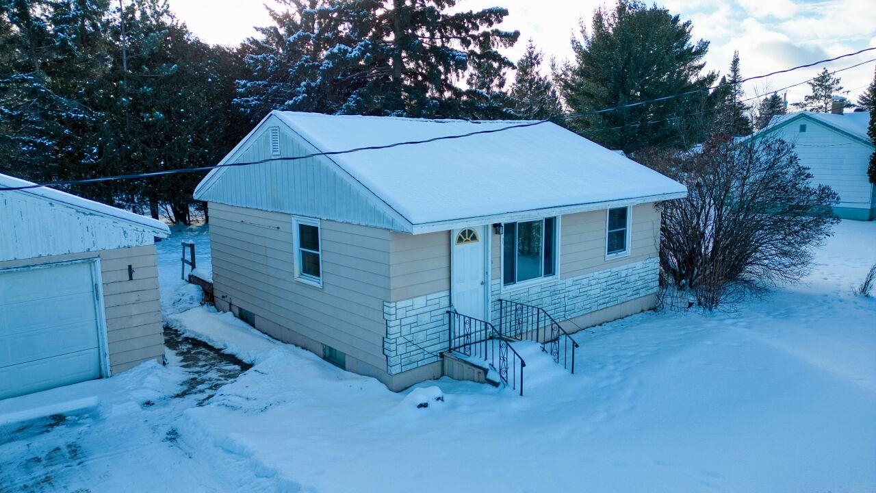 15 East 3rd Avenue South Aurora, MN 55705 - Photo 22 of 27 View of front facade featuring stone siding and a garage
