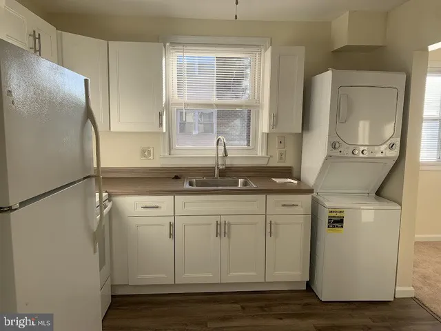 a kitchen with a sink and a refrigerator