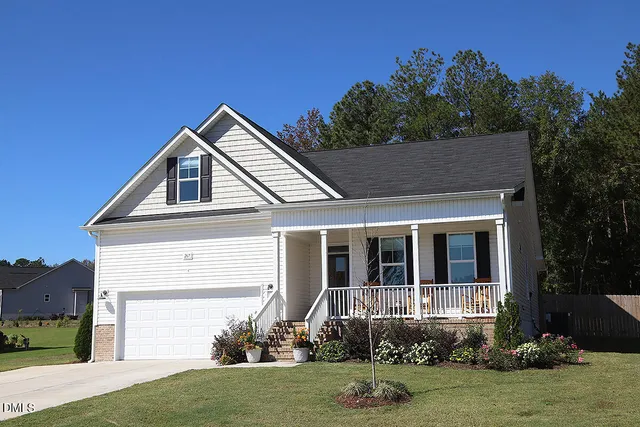 a front view of a house with a yard and garage