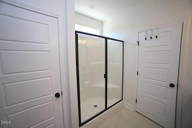 a bathroom with a shower and a glass door