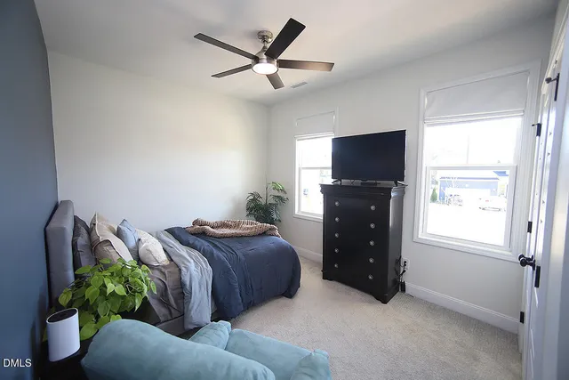 a bedroom with a bed and a television