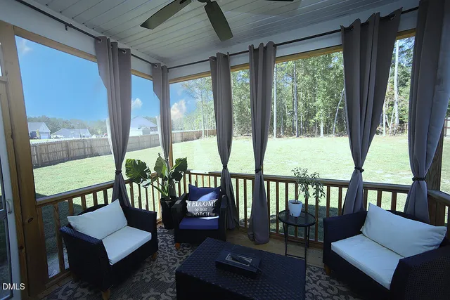 a balcony with furniture and a potted plant