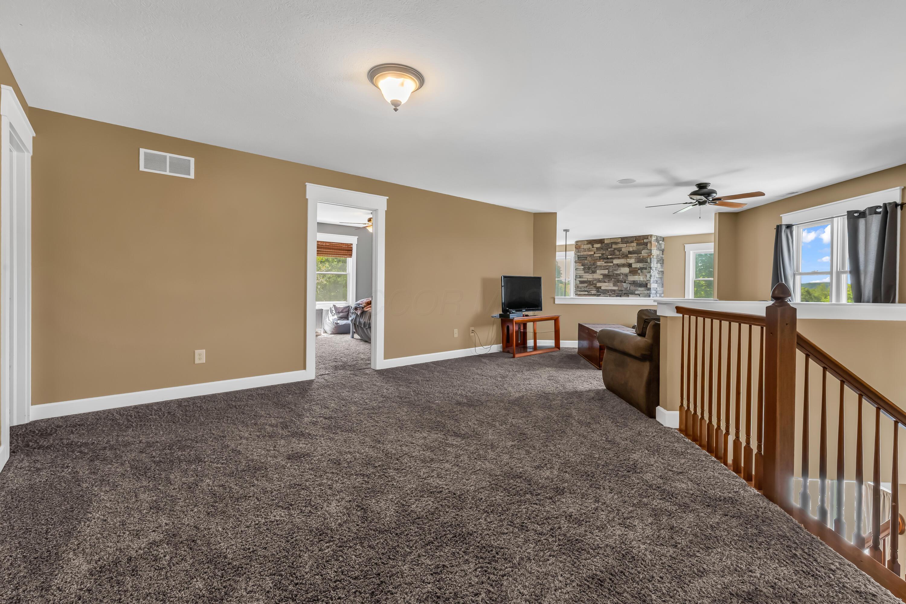 16689 Bailor Road Laurelville, OH 43135 - Photo 30 of 73 • Light sand carpet
• Tan painted walls
• Ceiling fan
• (2) ceiling lights
• 1/2 wall overlooks
Great Room