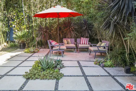 an outdoor space with furniture and umbrella