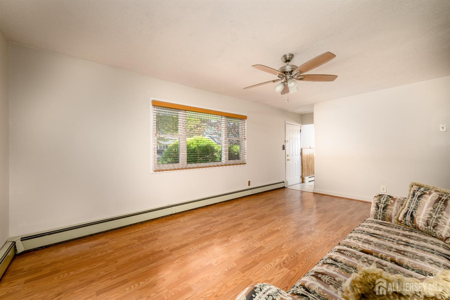 34 Kenmore Road Edison, NJ 08817 - Photo 10 of 22 an empty room with window and a ceiling fan