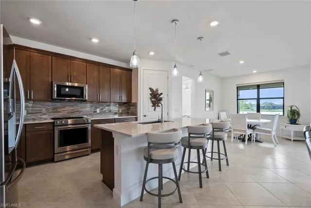a large kitchen with a table and chairs
