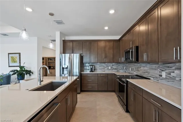 a large kitchen with stainless steel appliances kitchen island granite countertop a large counter top stainless steel appliances and cabinets
