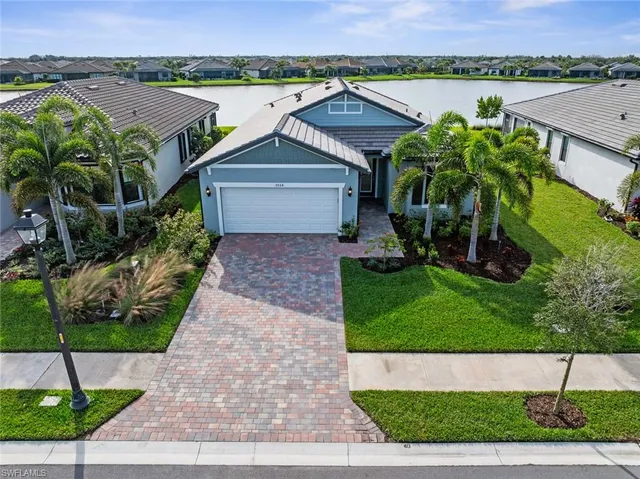 an aerial view of a house with a yard and potted plants