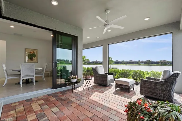 a living room with furniture dining table and a floor to ceiling window