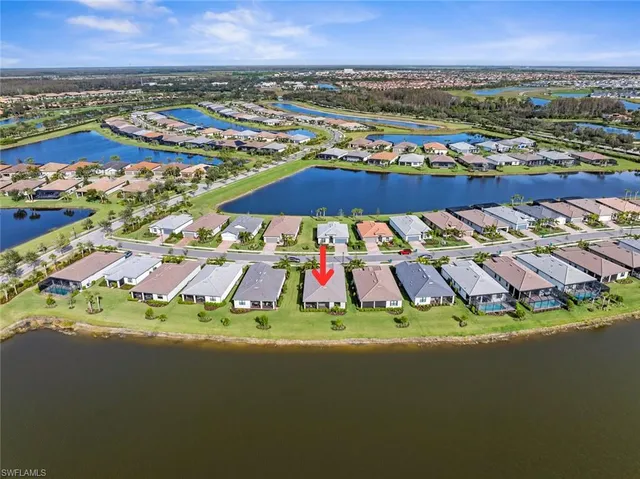 an aerial view of residential houses with outdoor space and river