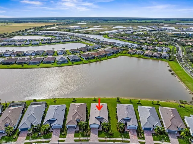an aerial view of residential building and lake