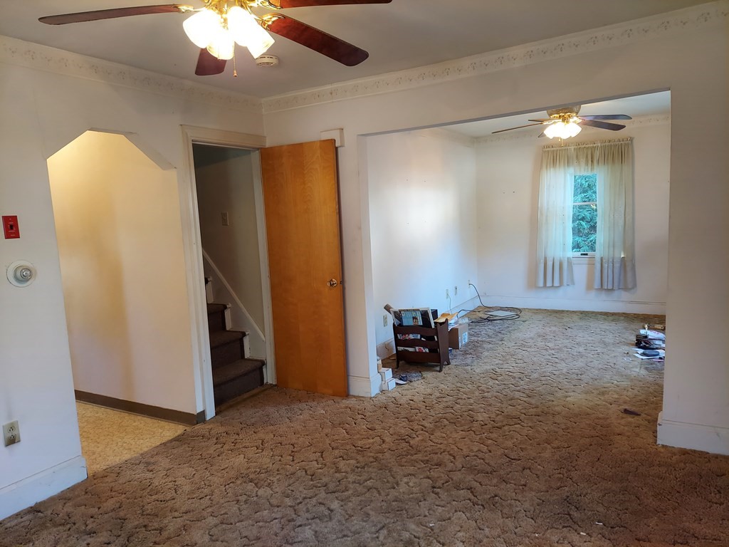 13 Saybrook Road Worcester, MA 01604 - Photo 7 of 40 an empty room with chandelier fan and windows