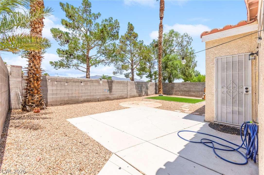 7353 Ridge Star Court Las Vegas, NV 89131 - Photo 33 of 36 A private backyard oasis features ample patio space for enjoyment under string lighting.