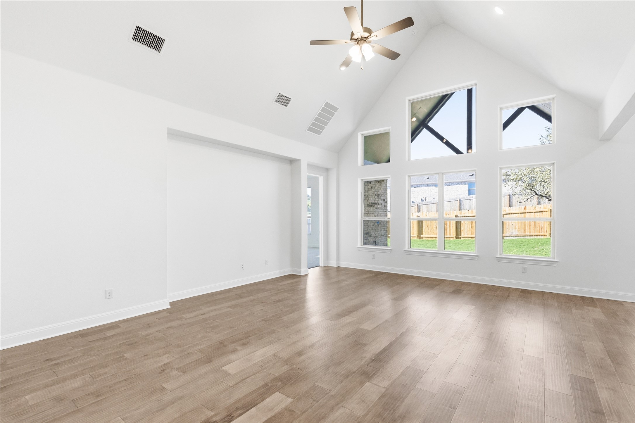 308 Frio Spgs Trail Georgetown, TX 78628 - Photo 12 of 32 a view of an empty room with a window and wooden floor