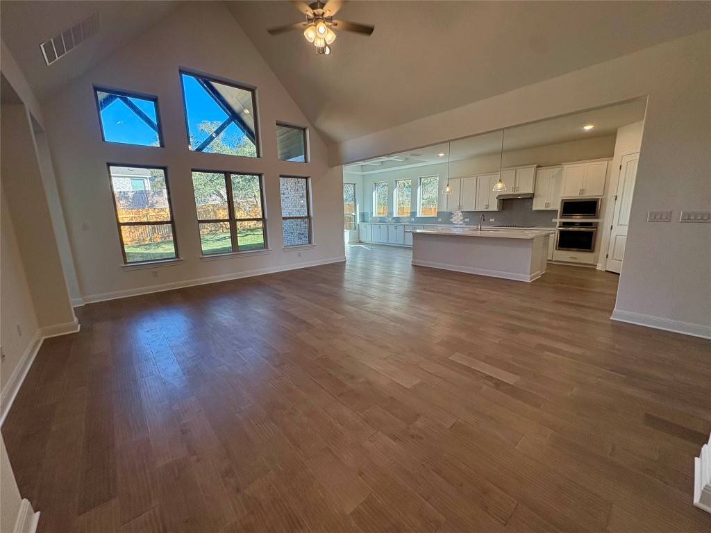 308 Frio Spgs Trail Georgetown, TX 78628 - Photo 3 of 13 a view of an empty room with a window and wooden floor