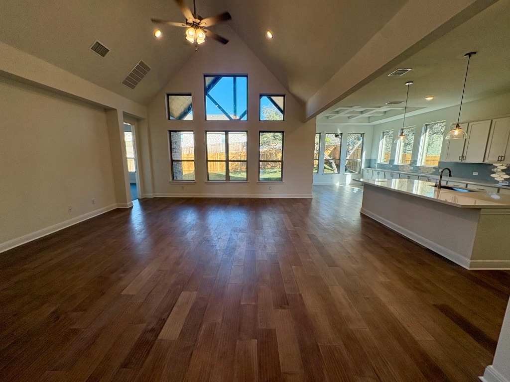 308 Frio Spgs Trail Georgetown, TX 78628 - Photo 4 of 13 a view of an empty room with wooden floor and a window