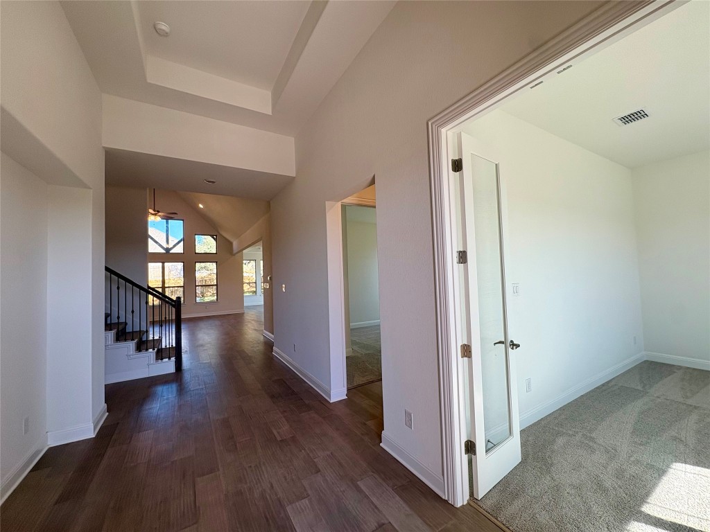 308 Frio Spgs Trail Georgetown, TX 78628 - Photo 5 of 13 a view of a hallway with wooden floor and a living room
