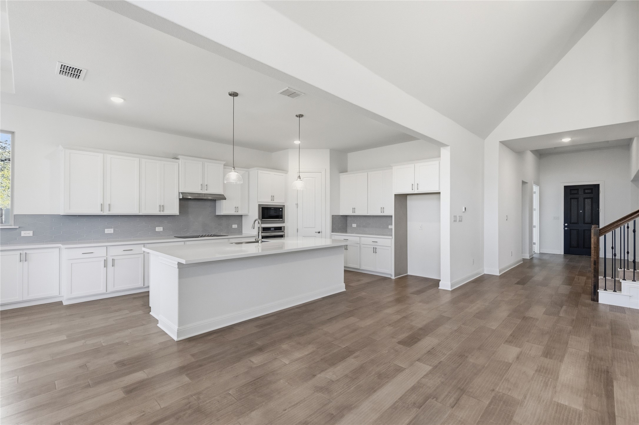 308 Frio Spgs Trail Georgetown, TX 78628 - Photo 7 of 32 a kitchen with white cabinets and stainless steel appliances