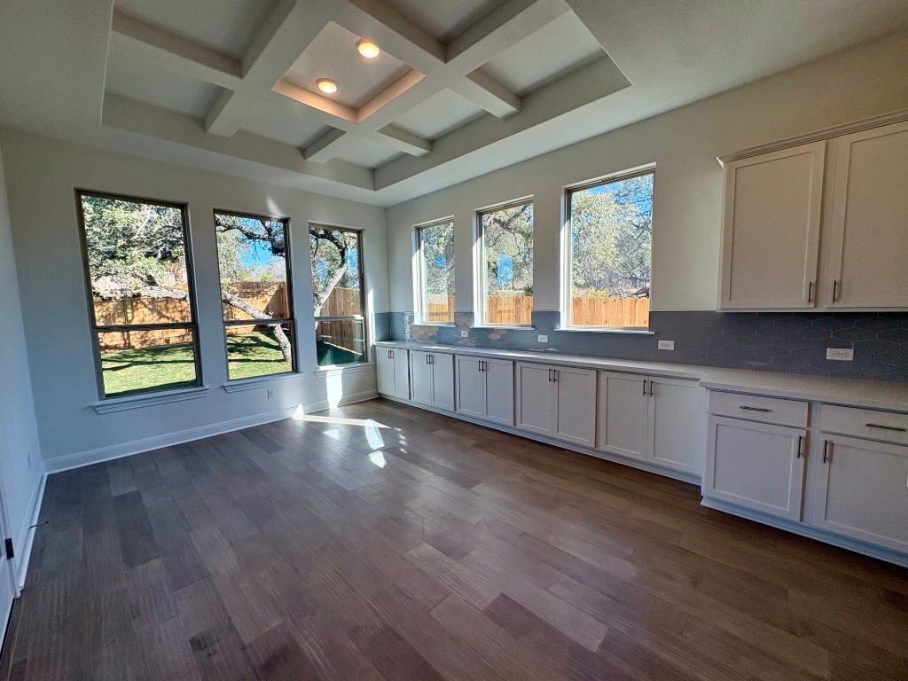 308 Frio Spgs Trail Georgetown, TX 78628 - Photo 8 of 13 a view of an empty room with wooden floor and a window