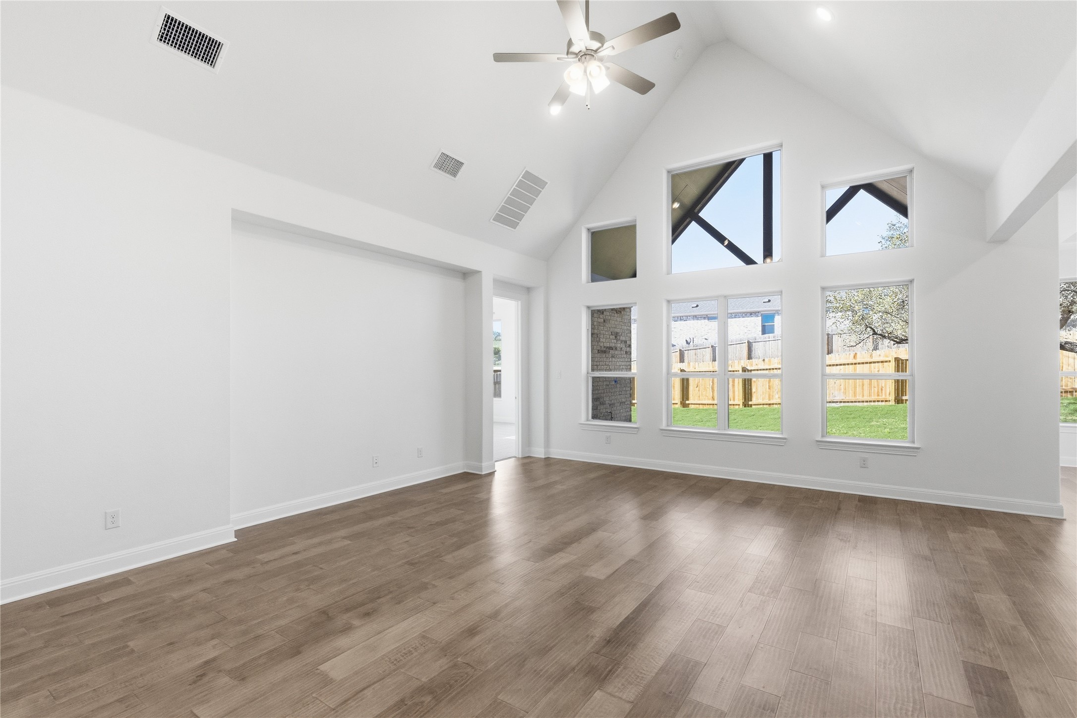 308 Frio Spgs Trail Georgetown, TX 78628 - Photo 10 of 32 wooden floor in an empty room with a window