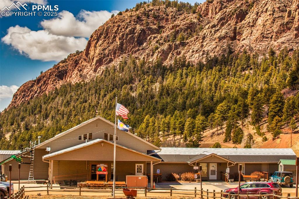 1289 Yorktown Road Cripple Creek, CO 80813 - Photo 23 of 35 a front view of a building with parking lot of large trees