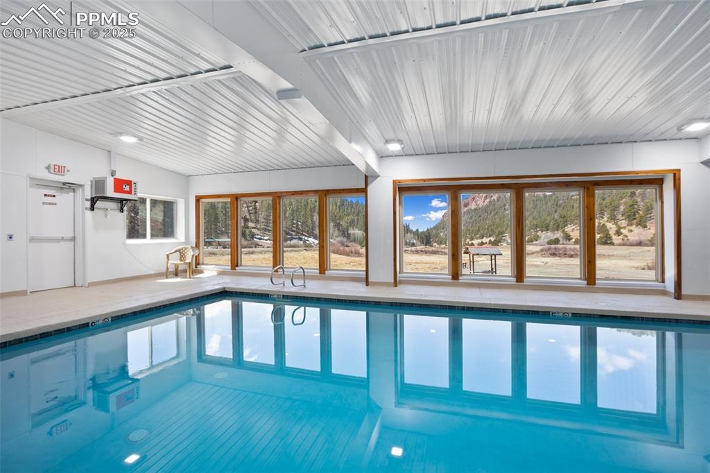 1289 Yorktown Road Cripple Creek, CO 80813 - Photo 28 of 35 a large white kitchen with wooden floor and large windows