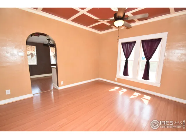 a kitchen with stainless steel appliances granite countertop a sink a stove and a wooden floors