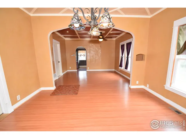 a view of a room with window wooden floor and a ceiling fan