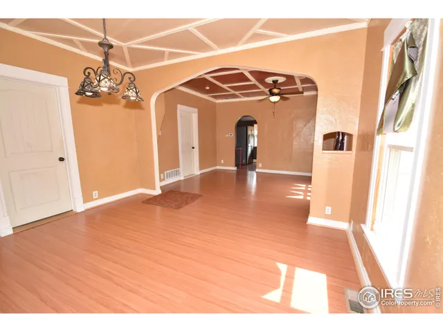 a view interior of a house with wooden floor and a ceiling fan