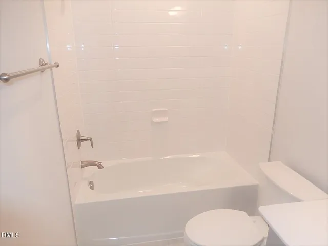 a bathroom with a toilet and a bathtub