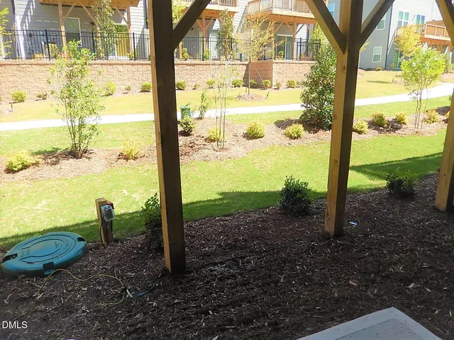 a view of a garden with large trees