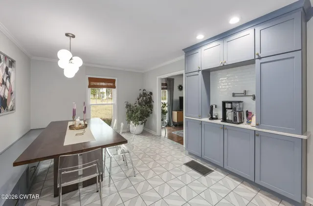 a dining room with furniture and window