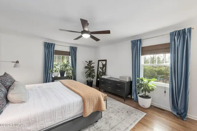 a bedroom with a bed and a potted plant
