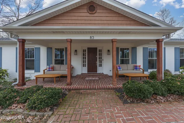 a view of a patio with table and chairs