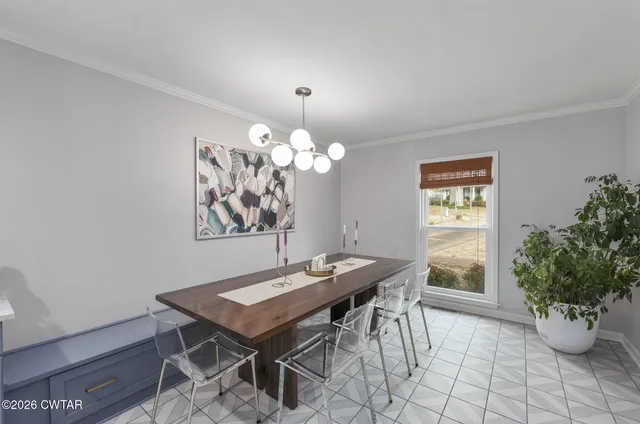 a view of a dining room with furniture and a potted plant