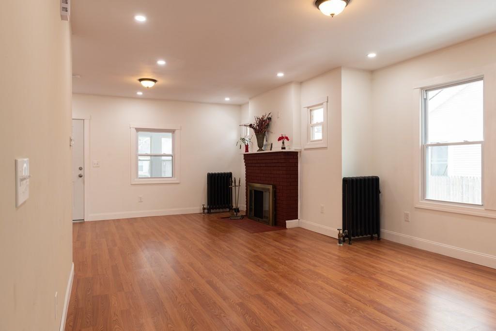 206 Marsden Street Springfield, MA 01109 - Photo 3 of 21 an empty room with windows and fireplace