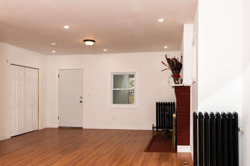 206 Marsden Street Springfield, MA 01109 - Photo 4 of 21 wooden floor in a hall with a window and a potted plant