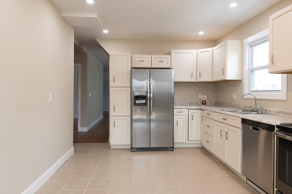 206 Marsden Street Springfield, MA 01109 - Photo 7 of 21 a kitchen with stainless steel appliances granite countertop a refrigerator and a sink