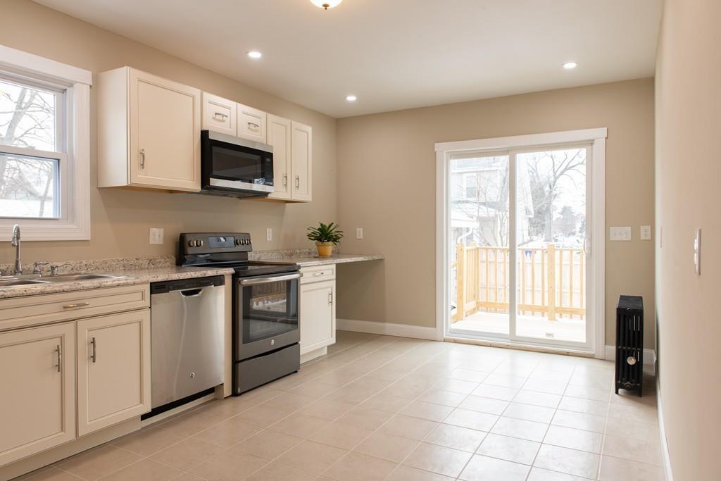 206 Marsden Street Springfield, MA 01109 - Photo 8 of 21 a kitchen with stainless steel appliances granite countertop a stove a sink and a microwave